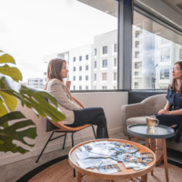 Two colleagues discuss in a cocooning space, relaxing around a cup of tea - premises in Lyon