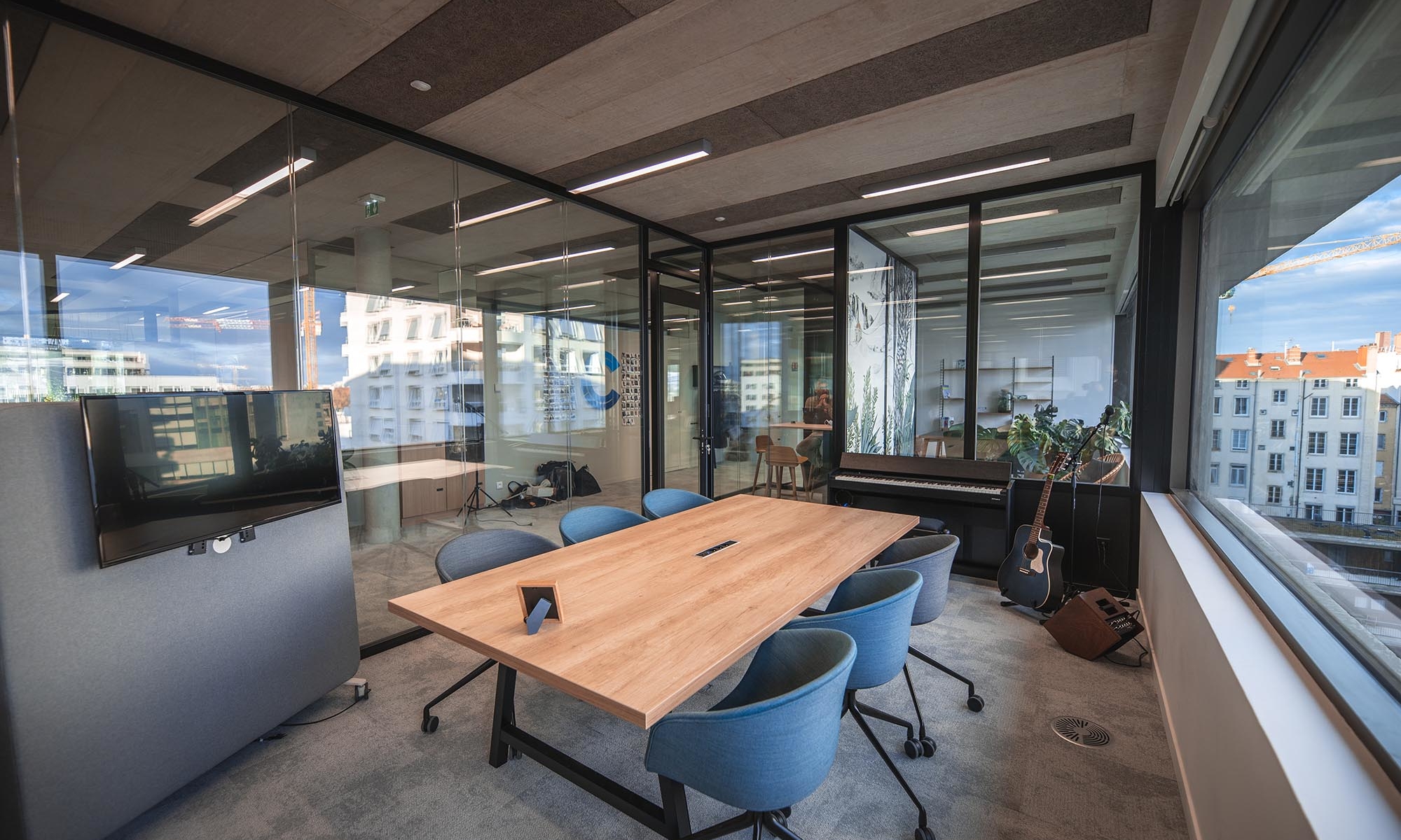 Modern meeting room with musical instruments (piano, guitar)