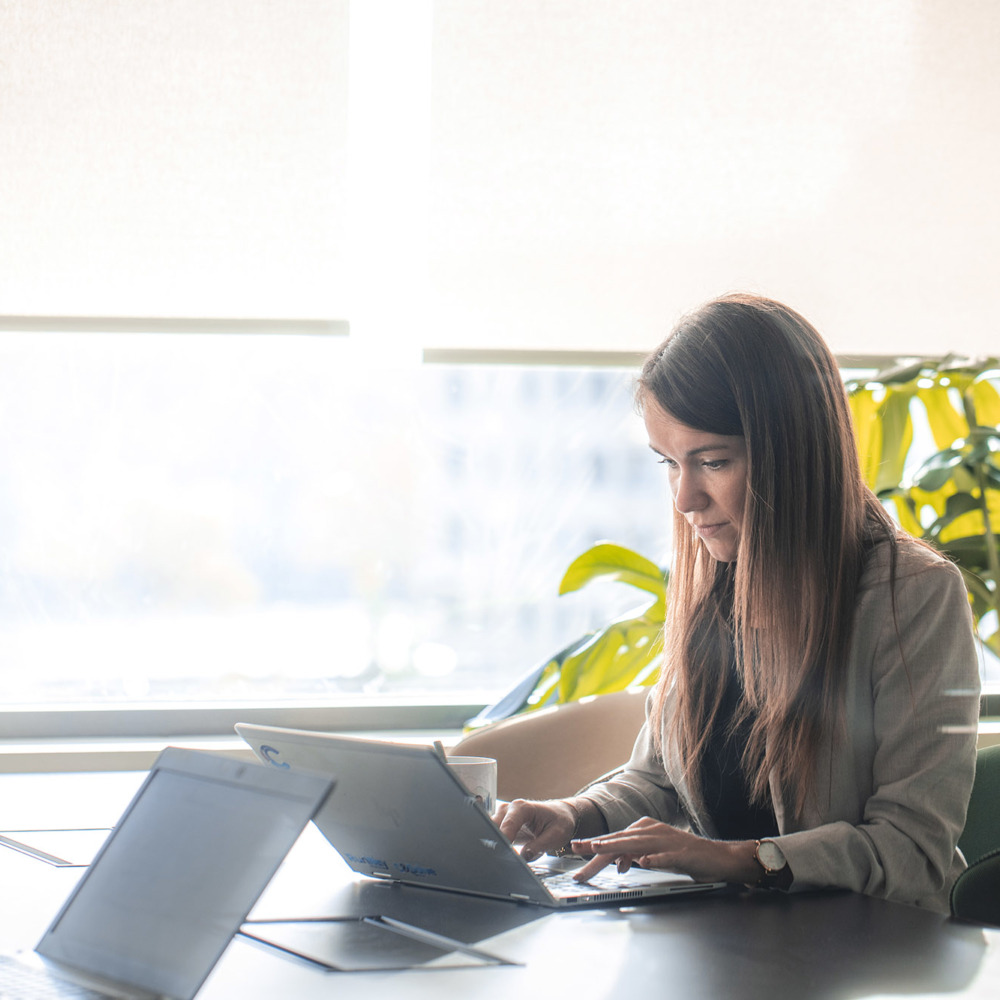 Focus on a woman, in charge of communication, thinking about future projects to improve the company's team cohesion