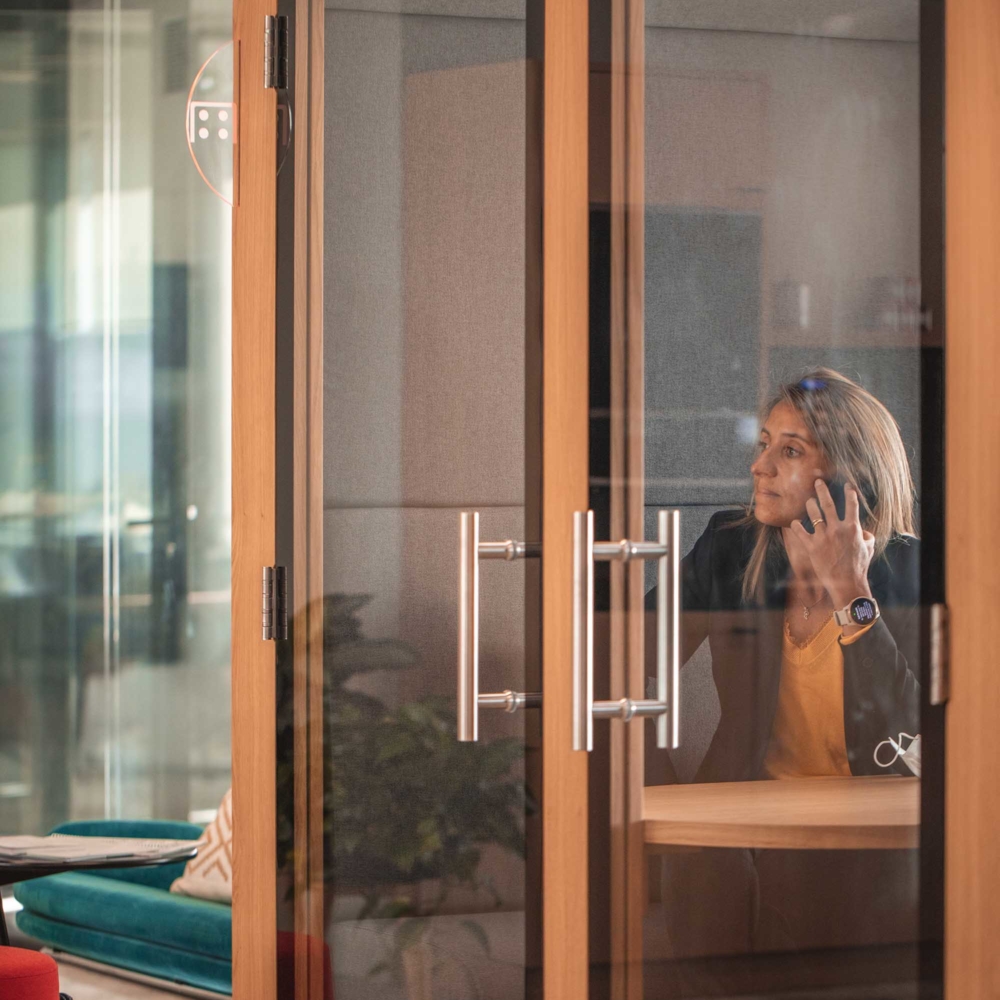 woman is having a business discussion while holding her smartphone by ear