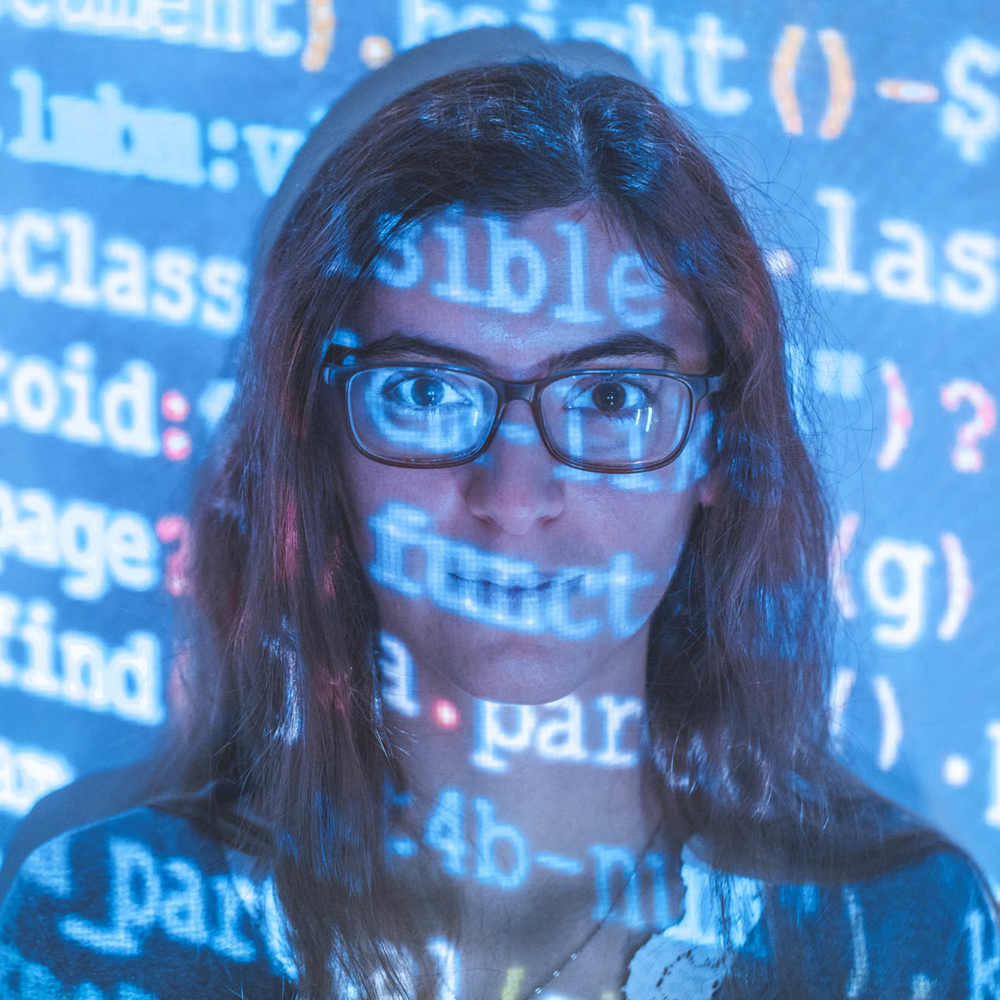 Focus on a consultant's face, reflection on her computer coding face