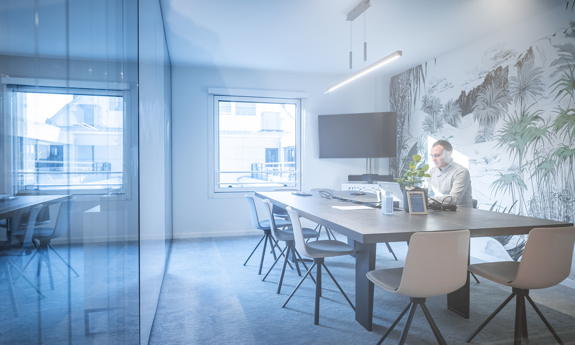 Businessman working on laptop in a modern meeting room