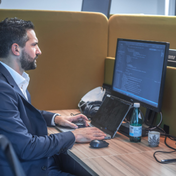 Manager working in the coworking space with his colleagues