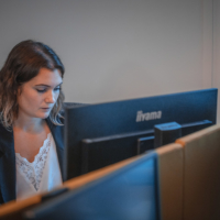 Young woman working on her computer looking for interesting candidates' profiles