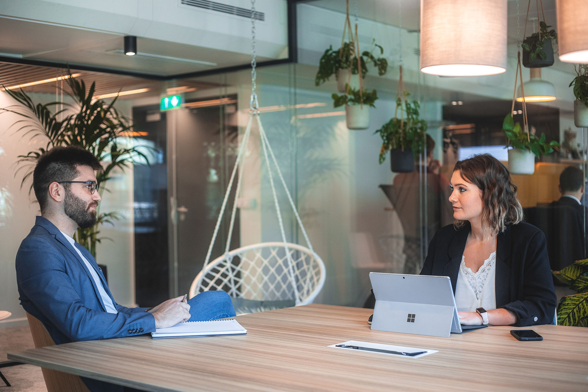 Picture of colleagues looking at laptop and working together meeting room.