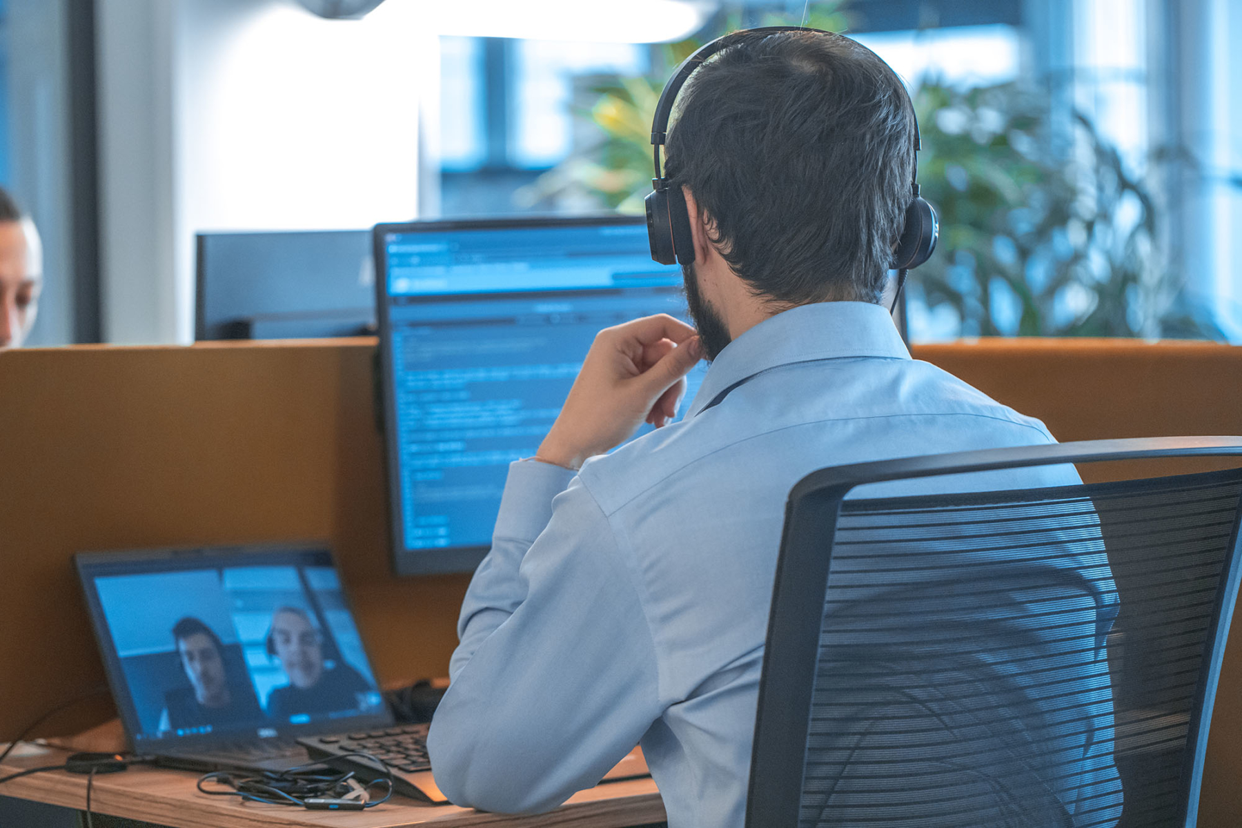 Man looking at several computer screens in night mode
